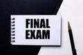 The words FINAL EXAM written in red on a black and white background near the pen Royalty Free Stock Photo