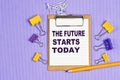 The words The future starts today written on a white notebook