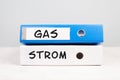 The words gas and electricity are standing in german language on the folders, increasing prices, high living expenses, financial Royalty Free Stock Photo
