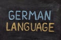 The words German Language handwritten with chalk on a blackboard Royalty Free Stock Photo