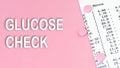 Words glucose check on pink background, medical concept, top view