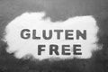 Words Gluten free written with flour on grey background, top view Royalty Free Stock Photo