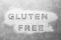 Words Gluten free written with flour on grey background, top view Royalty Free Stock Photo