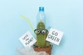 Words Go green, funny cactus and plastic rubbish