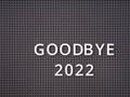 Words Goodbye 2022 spelled out with white letters on gray pegboard