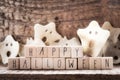 Words Happy Halloween on wooden cubes with group of scary ghost on wooden background, autumn mood horror halloween Royalty Free Stock Photo