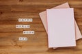 Words happy world book day made of wooden blocks with stack of books. Background for book holiday on wooden table top