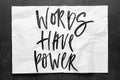 Words have power. Lettering on crumpled white paper. Handwritten text. Inspirational quotes.