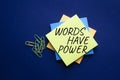 Words have power symbol. Yellow steaky note with words Words have power. Beautiful deep blue background. Business and Words have Royalty Free Stock Photo