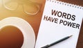 WORDS HAVE POWER - text on paper with cup of coffee and glasses on wooden background in sinlight Royalty Free Stock Photo