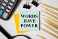 Words Have Power text written on a white notepad with colored pencils and a yellow background. text Royalty Free Stock Photo