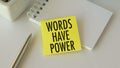 Words Have Power text on yellow sticky note with pen and notepad on white office desk, business concept Royalty Free Stock Photo