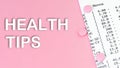 Words Health Tips on pink background, medical concept, top view