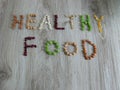 Words Healthy Food written with legumes or beans on wooden