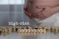 Words HIGH-RISK PREGNANCY composed of wooden letters