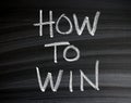 The words How To Win on a Blackboard