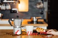 Words I LOVE YOU from red paper on a table with a coffee maker mug and cake with a girl`s hand on the background of home kitchen Royalty Free Stock Photo