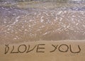 Words I LOVE YOU written on sand, with waves in background Royalty Free Stock Photo