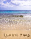 Words I LOVE YOU written on sand, with waves in background Royalty Free Stock Photo