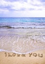 Words I LOVE YOU written on sand, with waves in background Royalty Free Stock Photo