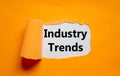 The words `industry trends` appearing behind torn orange paper. Business concept. Copy space