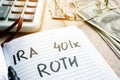 Words IRA 401k ROTH handwritten in a note. Retirement plans.