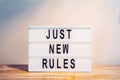 The words JUST NEW RULES on the lightbox. New beginnings, new life or new business concept Royalty Free Stock Photo