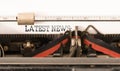 Words LATEST NEWS written on vintage typewriter