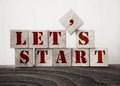 The words let`s start in old wood type - wooden cubes. Business startup concept Royalty Free Stock Photo