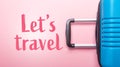 Words Let`s Travel Blue suitcase on pastel pink background Creative Summer holidays, vacation, travel concept Banner Royalty Free Stock Photo