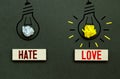 words LOVE and HATE on wooden blocks and light bulbs Royalty Free Stock Photo