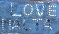 Words Love Malta, made of sea shells, on a wall Royalty Free Stock Photo