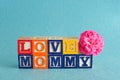 The words love mommy spelled with alphabet blocks