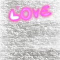 The words love and pink heart are written on white stones. Royalty Free Stock Photo