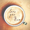 Words love you mum formed from coffee foam. Cup of cappuccino c