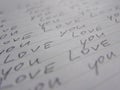 Words Love you written on lined white paper background. Perpective view Royalty Free Stock Photo