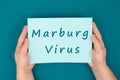 The words Marburg virus are standing on a paper, dangerous infectional disease, hemorrhagic fever, medical diagnosis, health issue