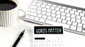 WORDS MATTER text on calculator with keyboard and coffee Royalty Free Stock Photo