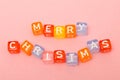 words merry christmas made of colorful blocks on pink background. Flat lay, top view - holidays, winter, christmas and new year ce Royalty Free Stock Photo