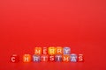 words merry christmas made of colorful blocks on red background. Flat lay, top view - holidays, winter, christmas and new year cel Royalty Free Stock Photo