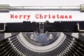 Words `Merry Christmas` typed on vintage typewriter. Christmas time