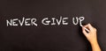 Words Never Give Up written on a blackboard Royalty Free Stock Photo