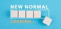 The words new normal are standing next to the loading bar, old and new life, time for a change Royalty Free Stock Photo