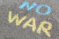 Words No War written with blue and yellow chalks on asphalt outdoors Royalty Free Stock Photo