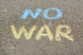 Words No War written with blue and yellow chalks on asphalt outdoors Royalty Free Stock Photo