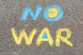 Words No War written with blue and yellow chalks on asphalt outdoors, top view Royalty Free Stock Photo