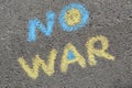 Words No War written with blue and yellow chalks on asphalt outdoors, top view Royalty Free Stock Photo