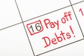 The words Pay off debts written on a calendar Royalty Free Stock Photo