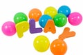 The words PLAY with colorful balls on white