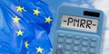 Words PNRR - The European Recovery and Resilience Plan against the crisis of the Covid virus pandemic - concept with calculator Royalty Free Stock Photo